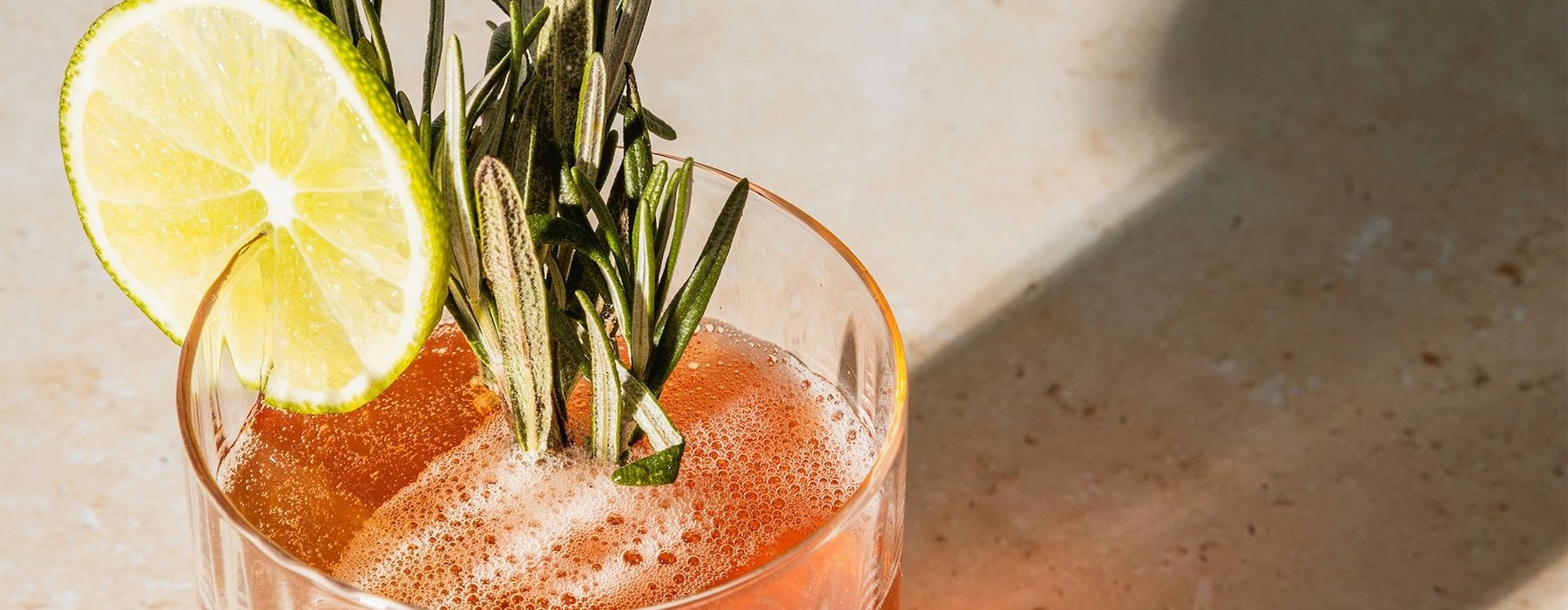 a glass with a drink and a lemon on top